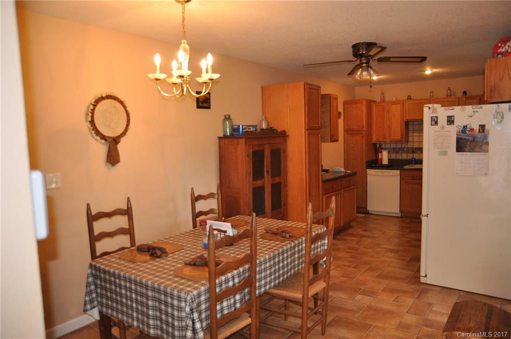 3801 White Store Road Wingate, NC 28174 - Photo 6 of 23 a dining room with stainless steel appliances kitchen island granite countertop a table chairs and a refrigerator