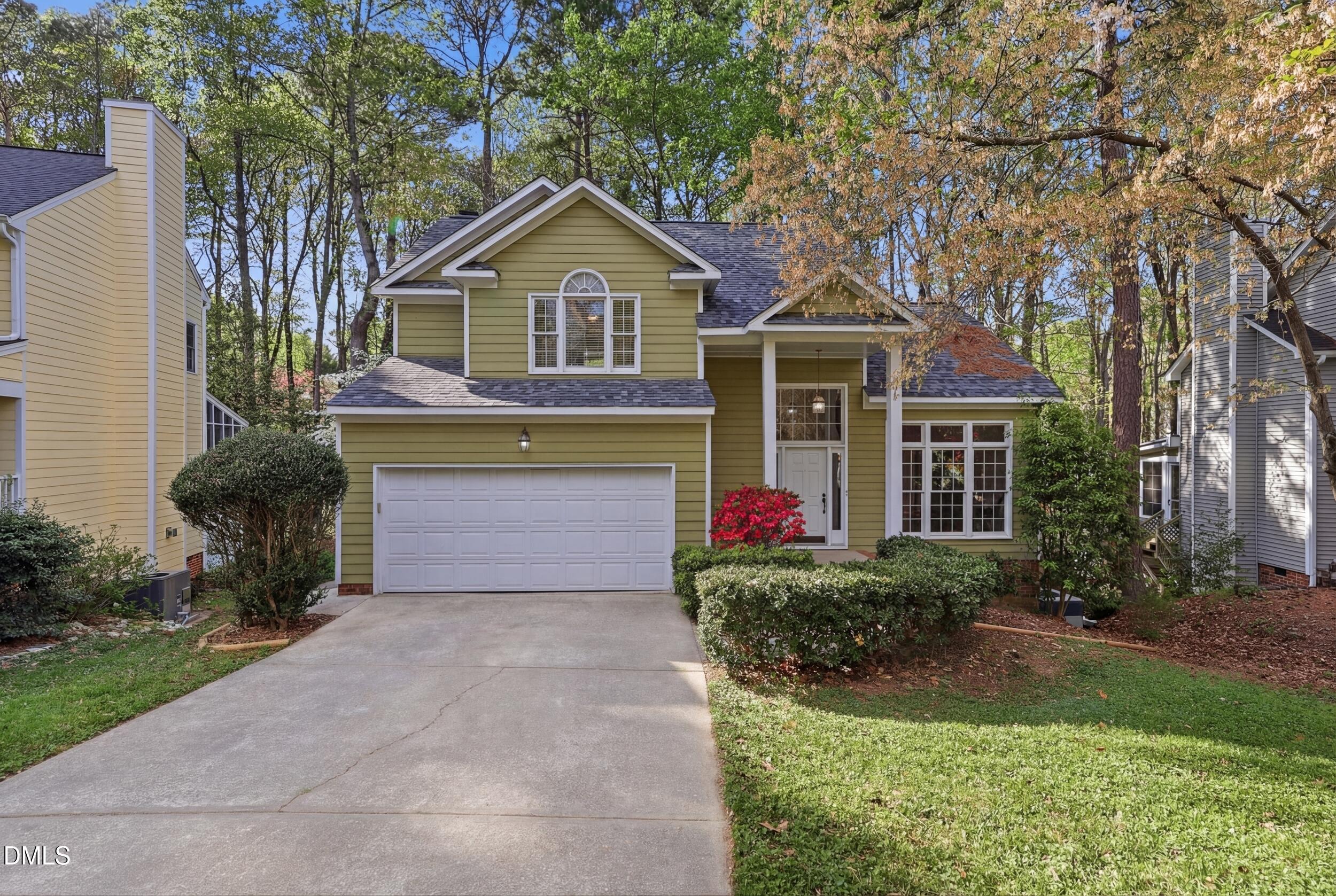107 Canyon Run Cary, NC 27513 - Photo 1 of 43 a front view of a house with a yard and garage