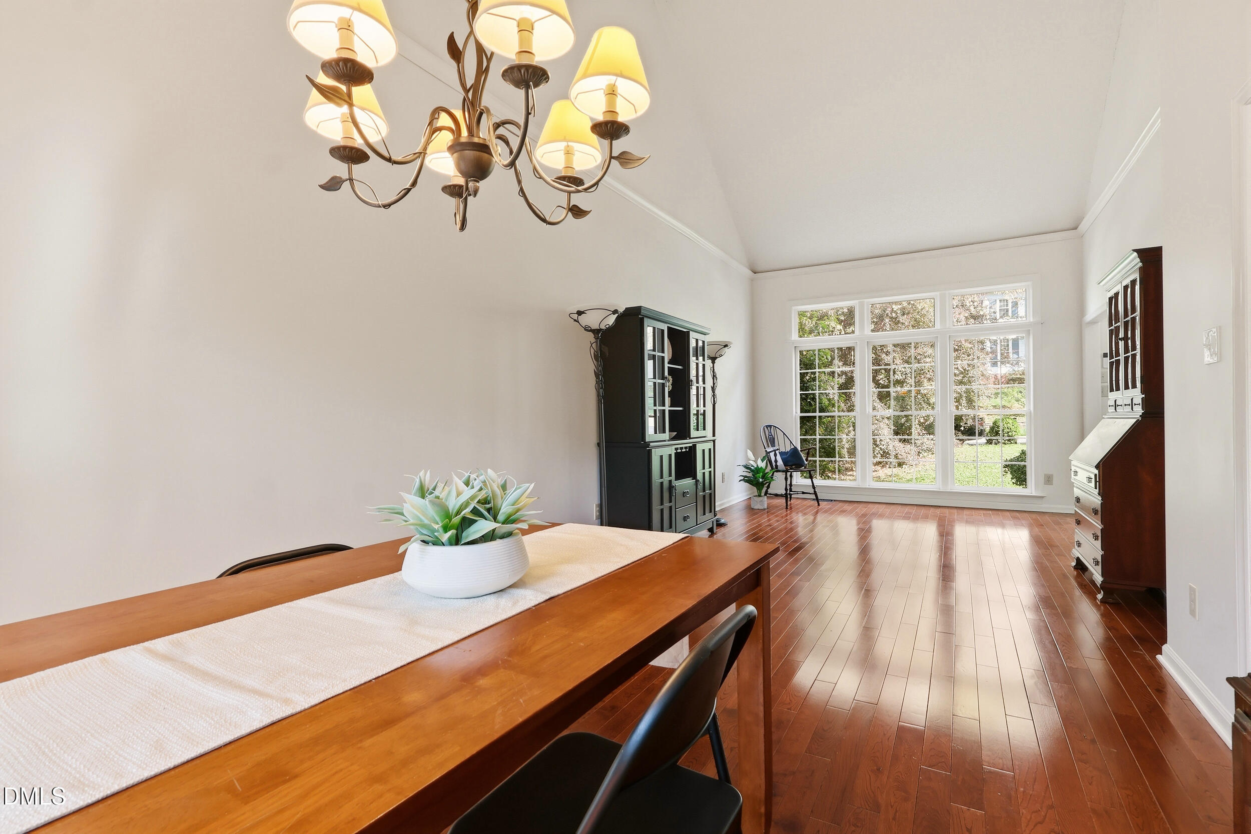 107 Canyon Run Cary, NC 27513 - Photo 11 of 43 a view of a dining room with furniture a chandelier windows and wooden floor