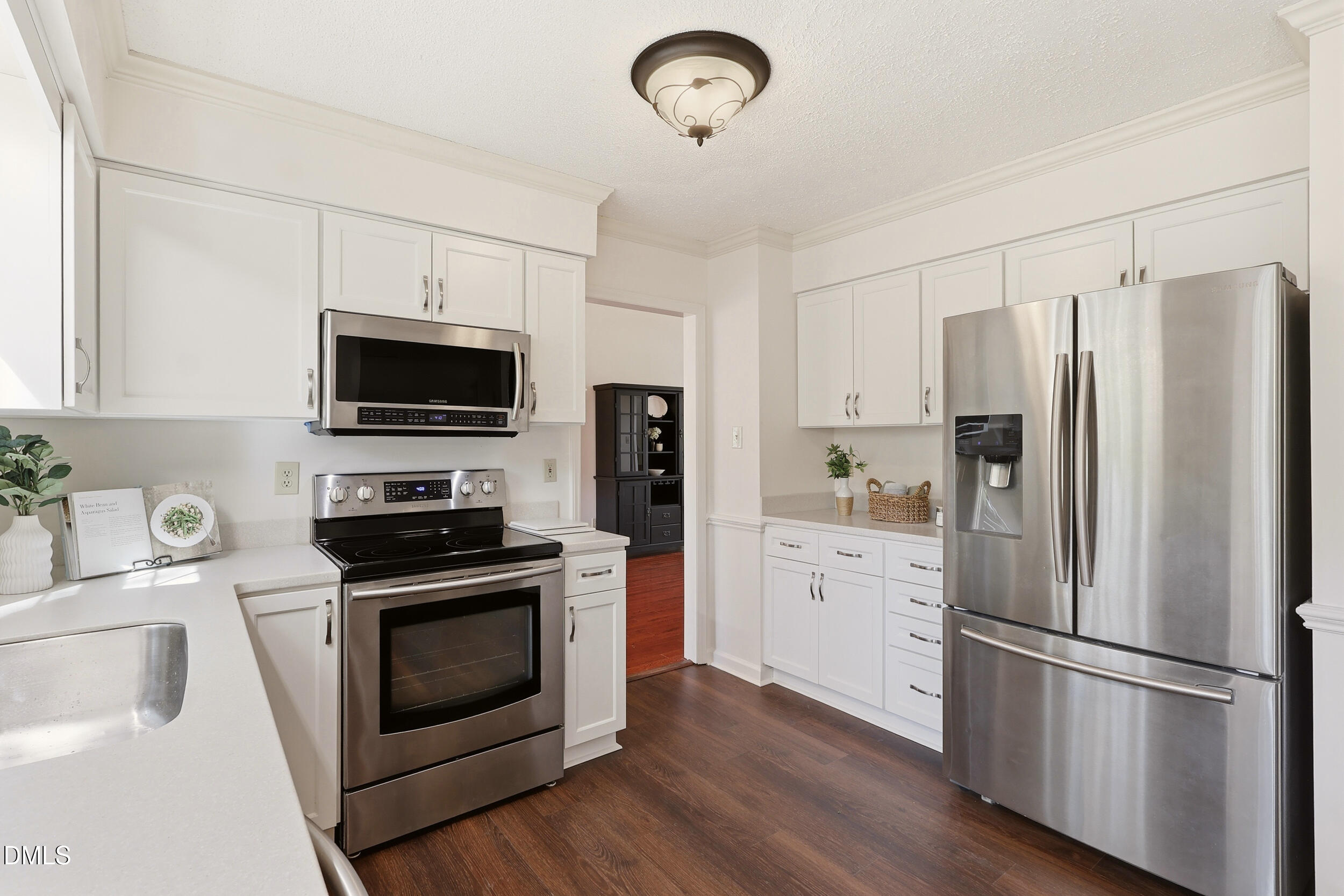 107 Canyon Run Cary, NC 27513 - Photo 13 of 43 a kitchen with a refrigerator stove and white cabinets