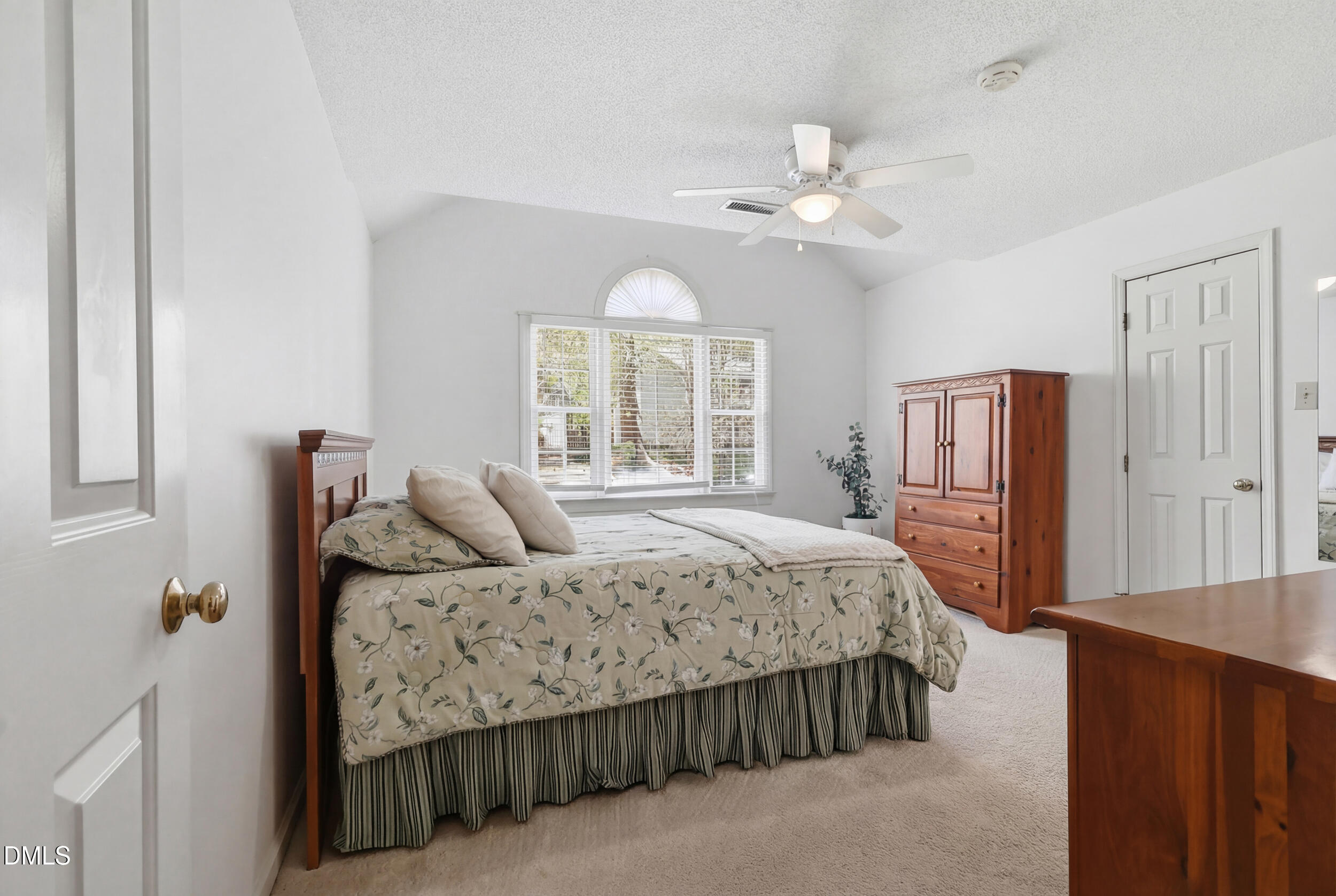 107 Canyon Run Cary, NC 27513 - Photo 25 of 43 a bedroom with a large bed and a chandelier