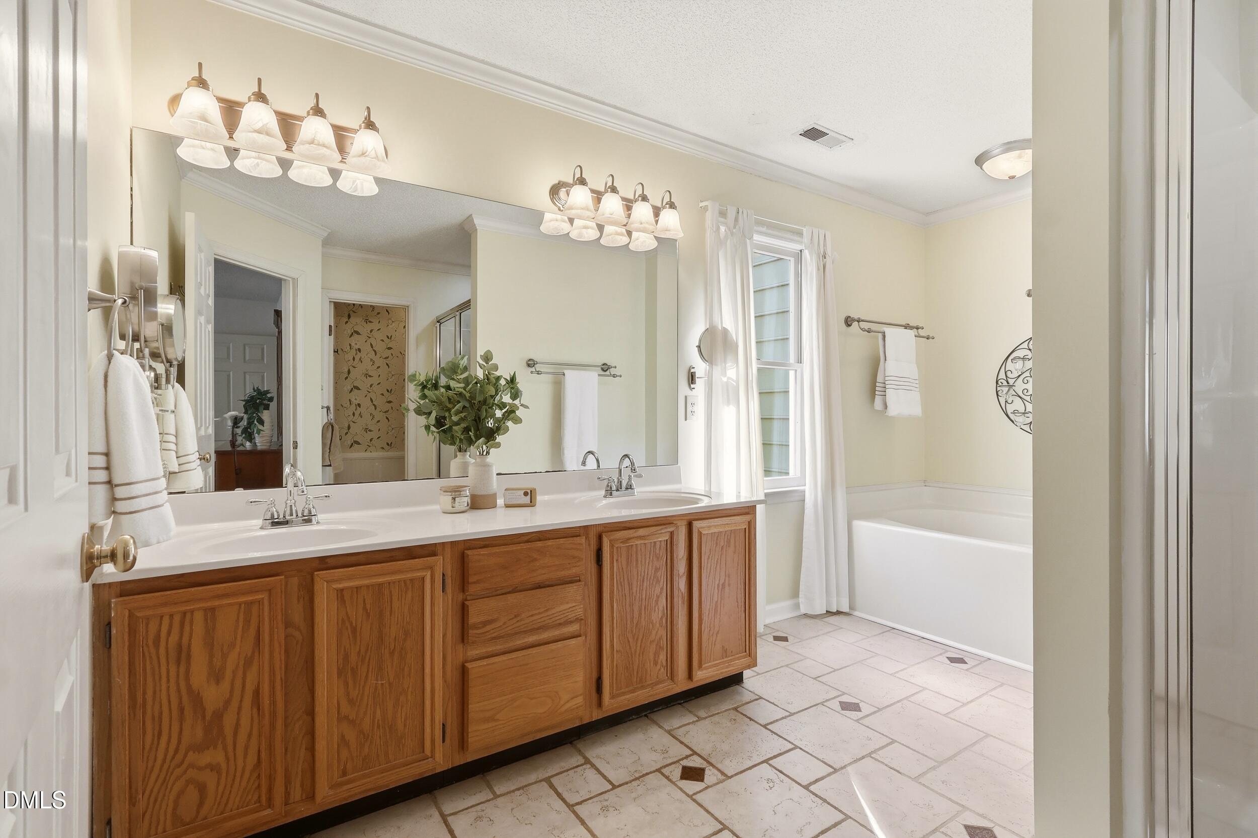 107 Canyon Run Cary, NC 27513 - Photo 28 of 43 a bathroom with a double vanity sink mirror double and bathtub