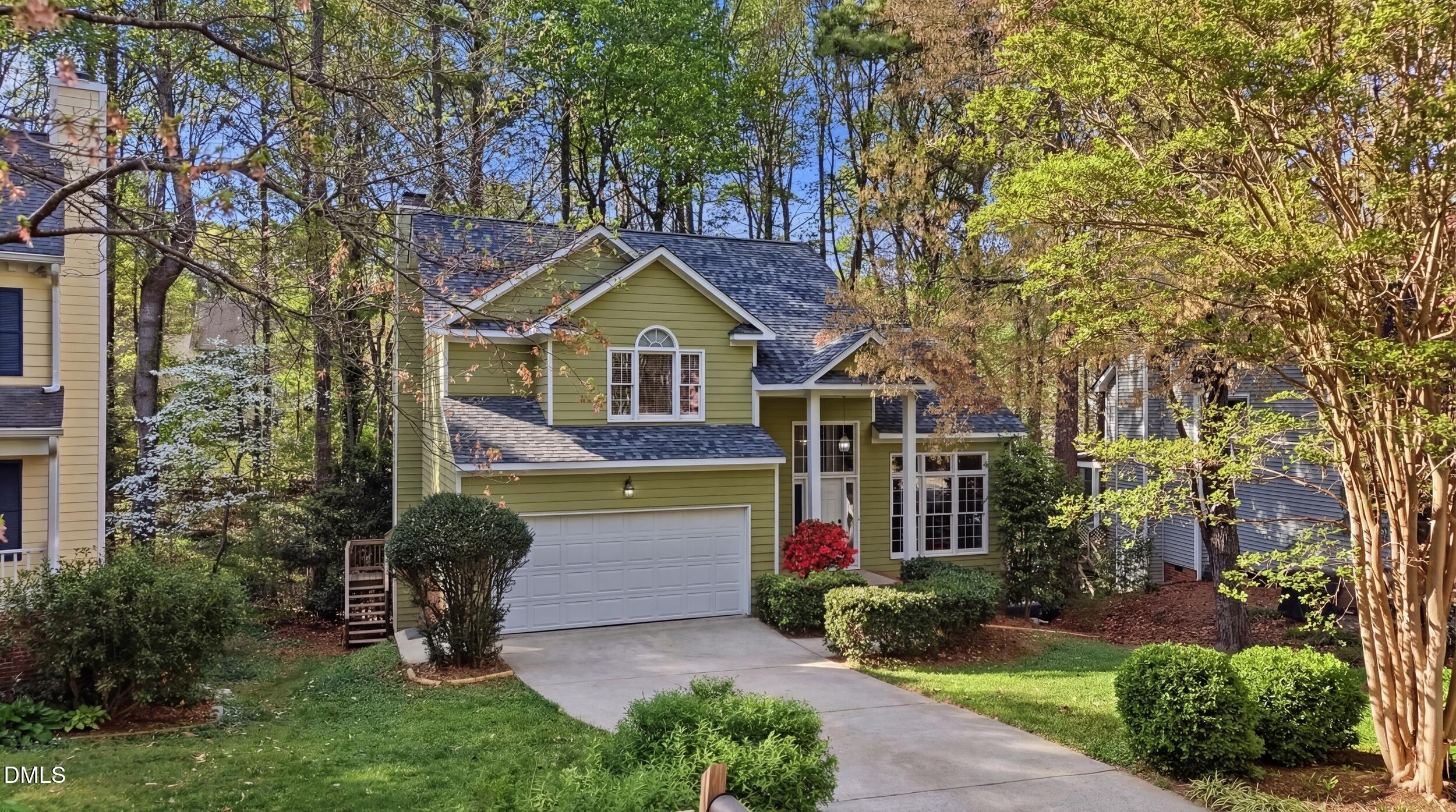 107 Canyon Run Cary, NC 27513 - Photo 2 of 43 a front view of a house with a garden