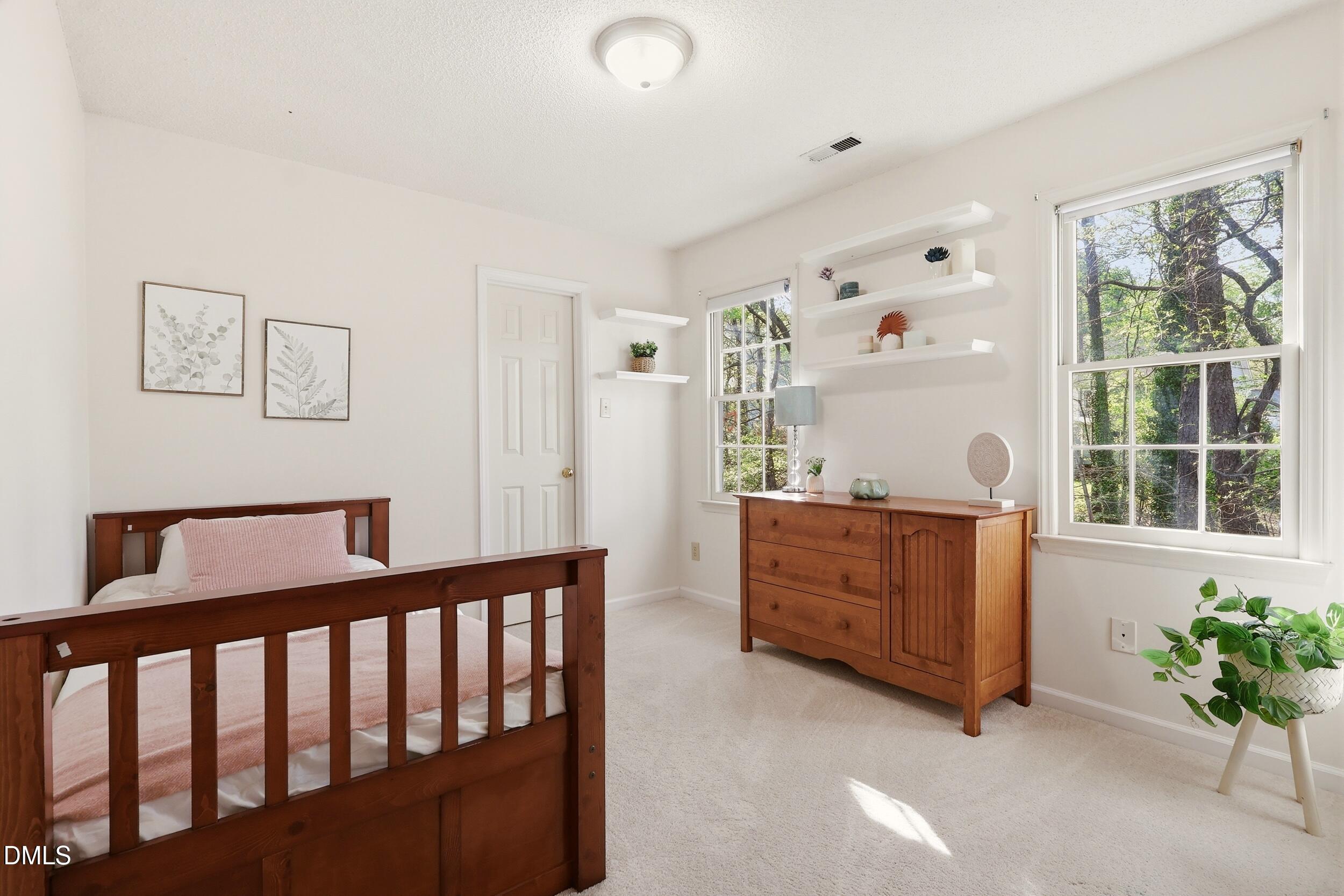 107 Canyon Run Cary, NC 27513 - Photo 32 of 43 a bedroom with furniture and a window