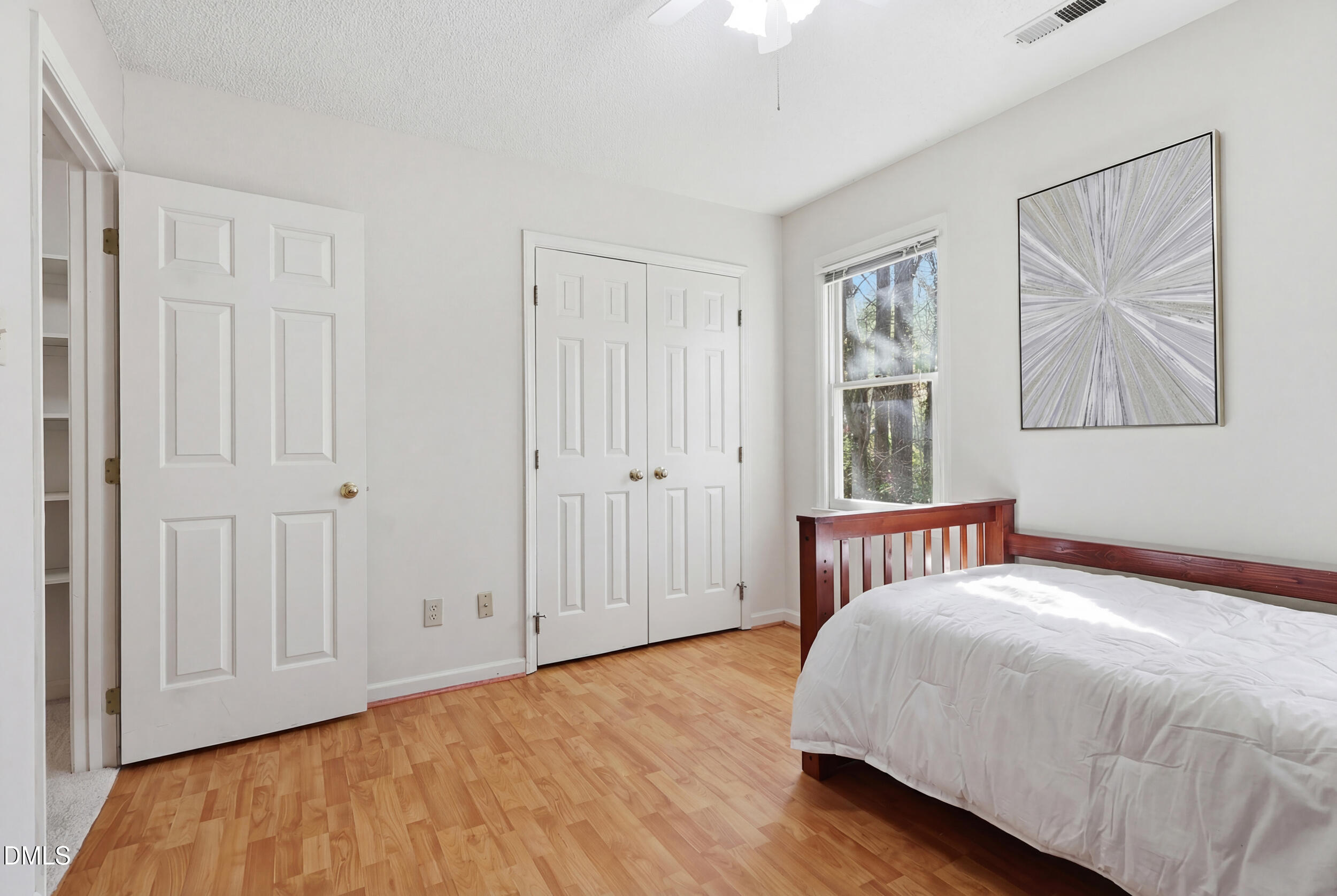 107 Canyon Run Cary, NC 27513 - Photo 36 of 43 a bedroom with a bed and wooden floor