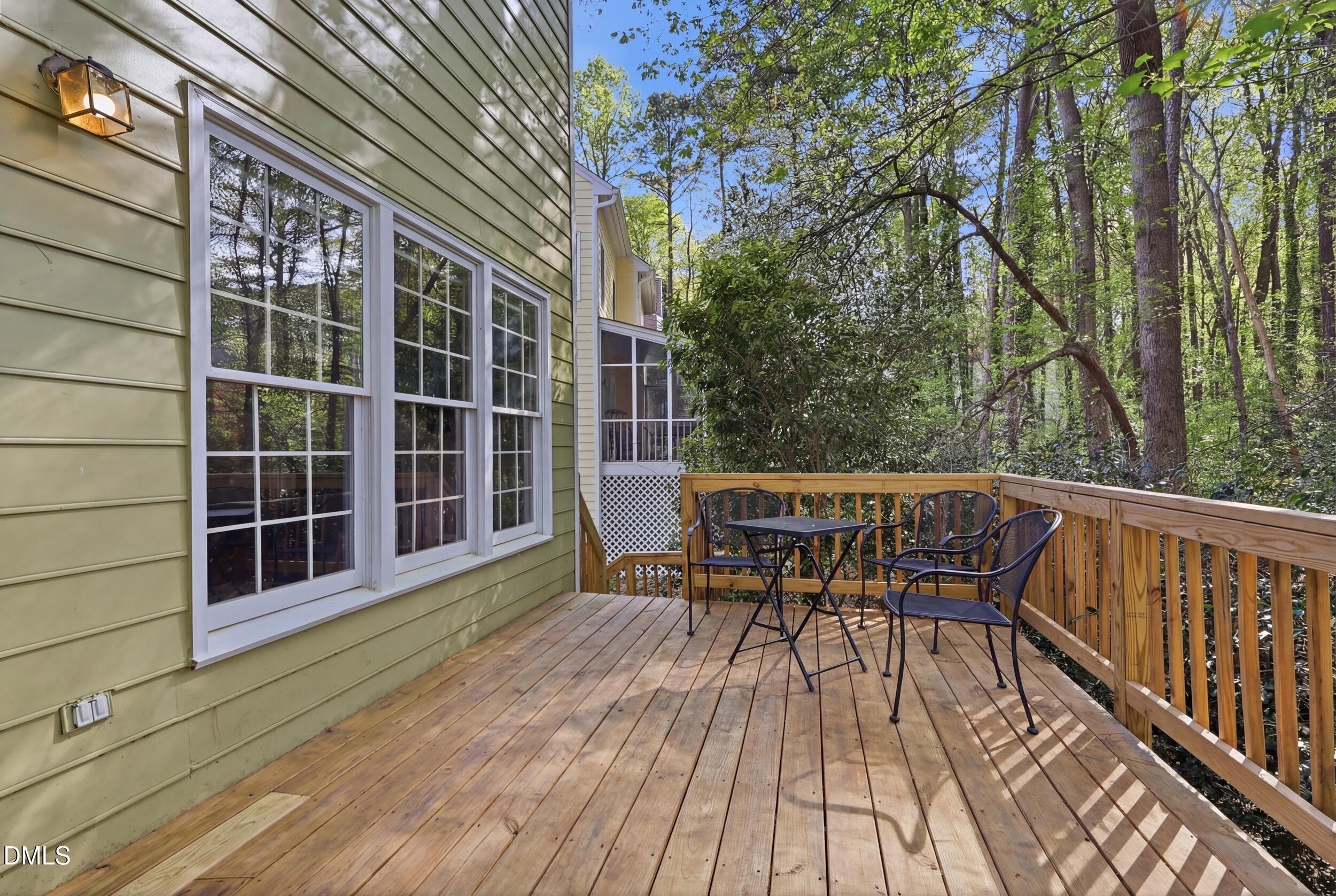 107 Canyon Run Cary, NC 27513 - Photo 40 of 43 a view of a roof deck with table and chairs with wooden floor and fence