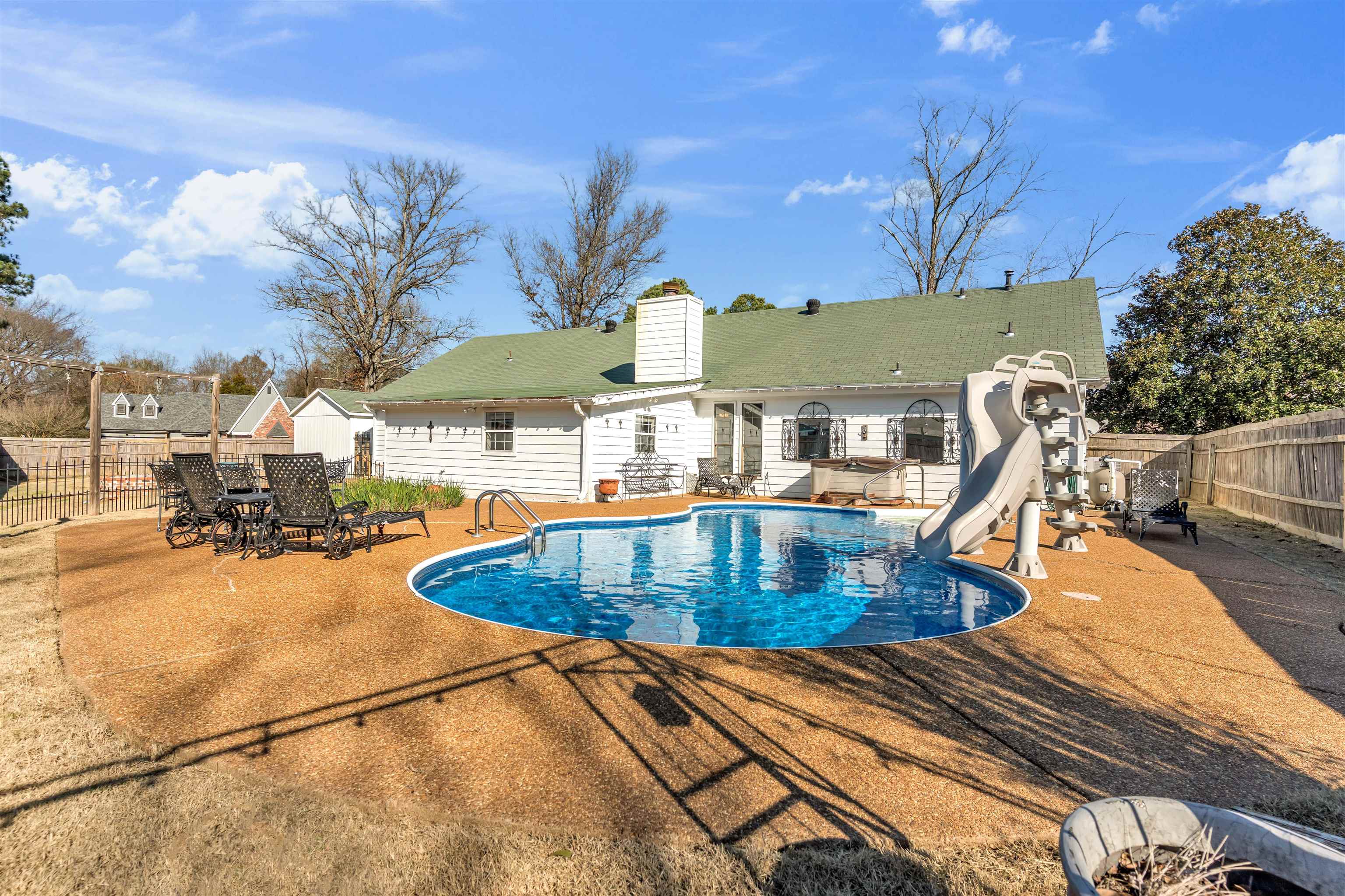 301 East Harpers Ferry Road Collierville, TN 38017 - Photo 32 of 39 View of swimming pool with a fenced backyard, a water slide, a patio area, and outdoor dining area