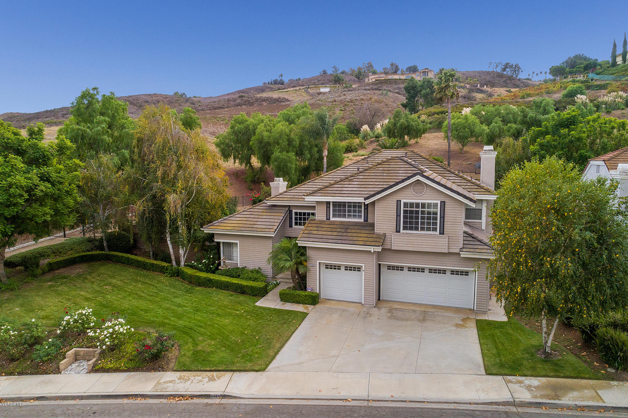 11618 Chestnut Ridge Street Moorpark, CA 93021 - Photo 3 of 33 a front view of a house with a garden and yard