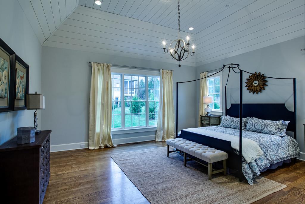 1205 Echo Lane Franklin, TN 37069 - Photo 20 of 29 a bedroom with a bed chandelier and a window