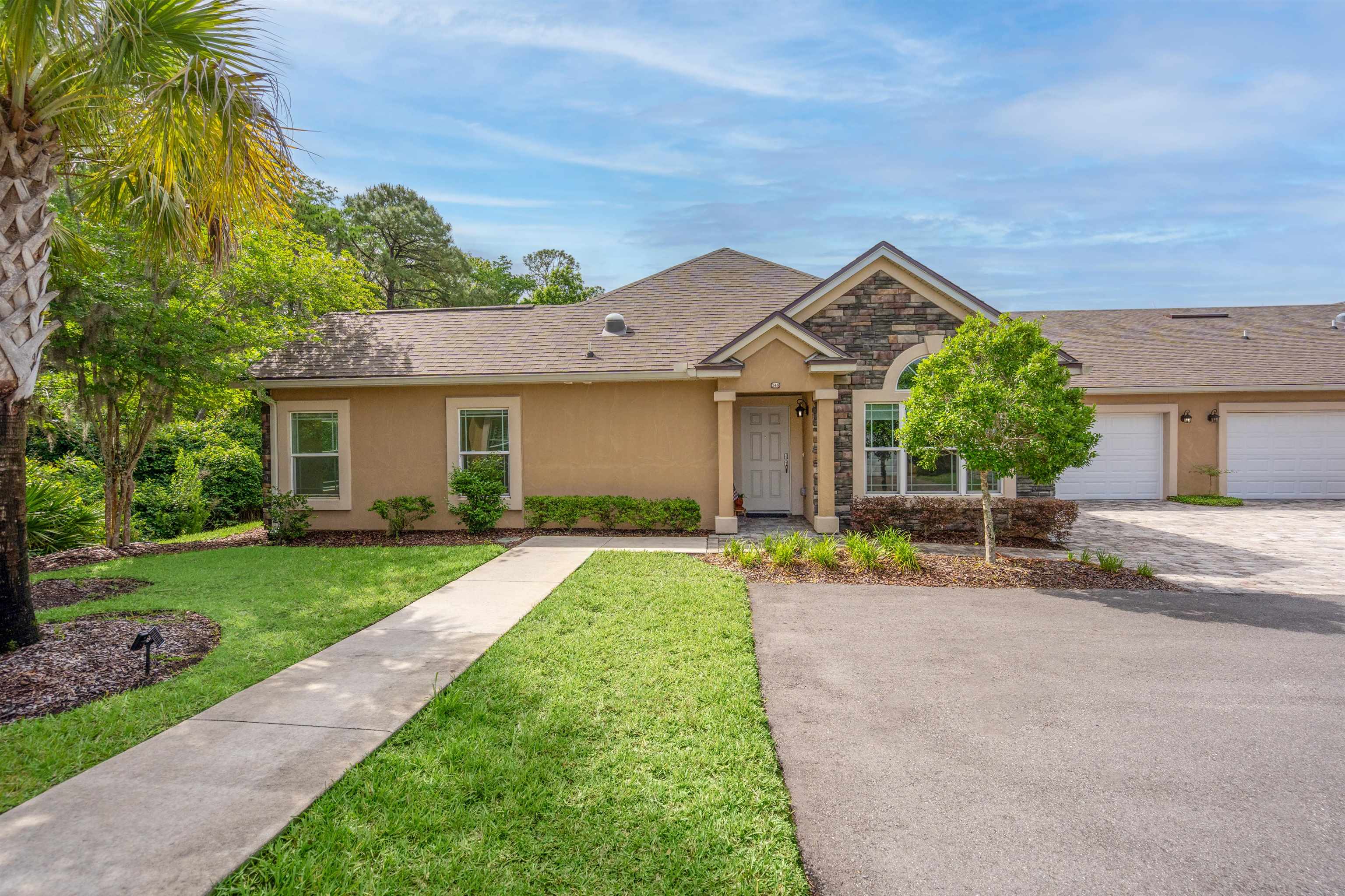 148 Timoga Trail St. Augustine, FL 32084 - Photo 1 of 46 a front view of a house with a yard and garage