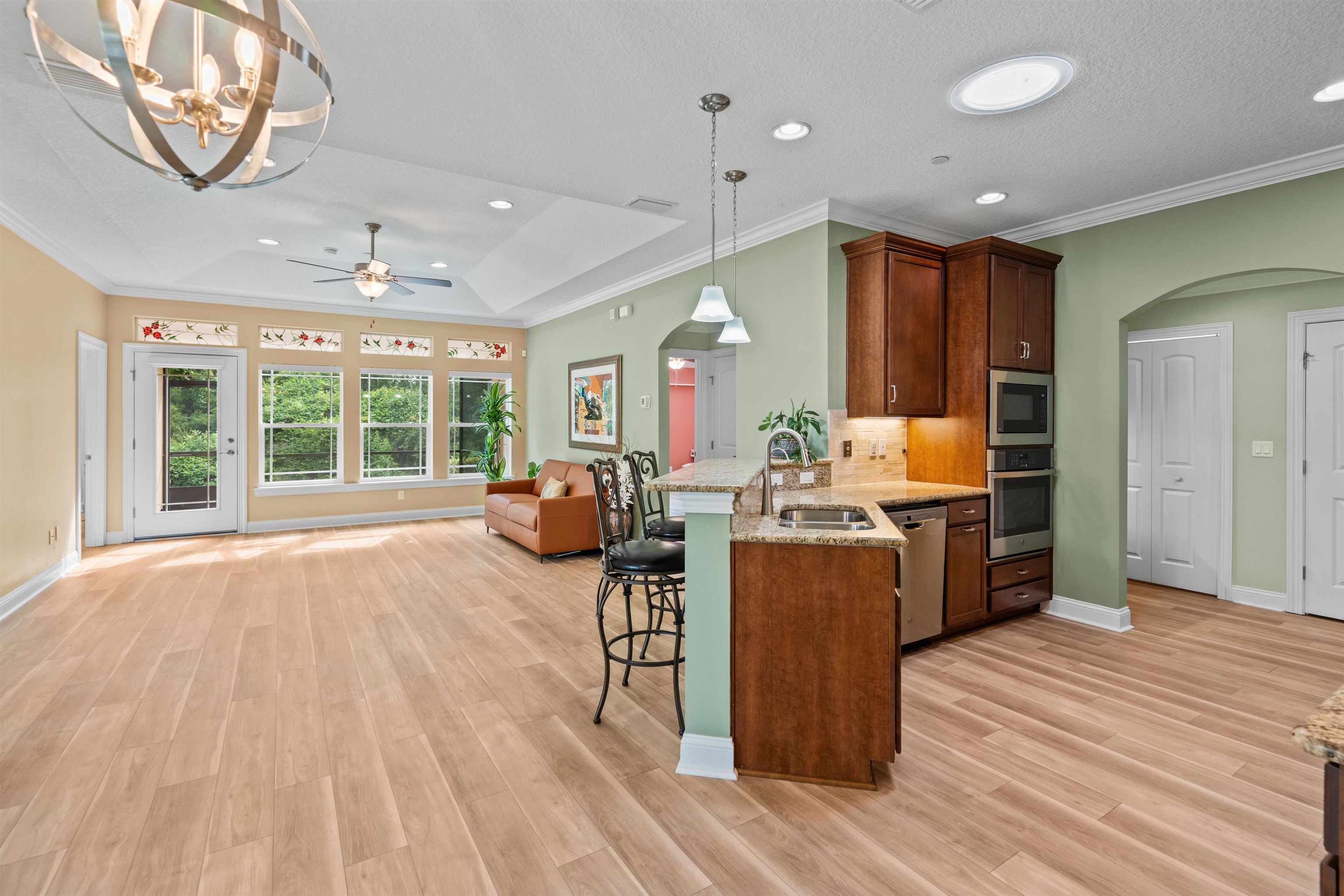 148 Timoga Trail St. Augustine, FL 32084 - Photo 14 of 46 a living room with furniture a large window with kitchen view