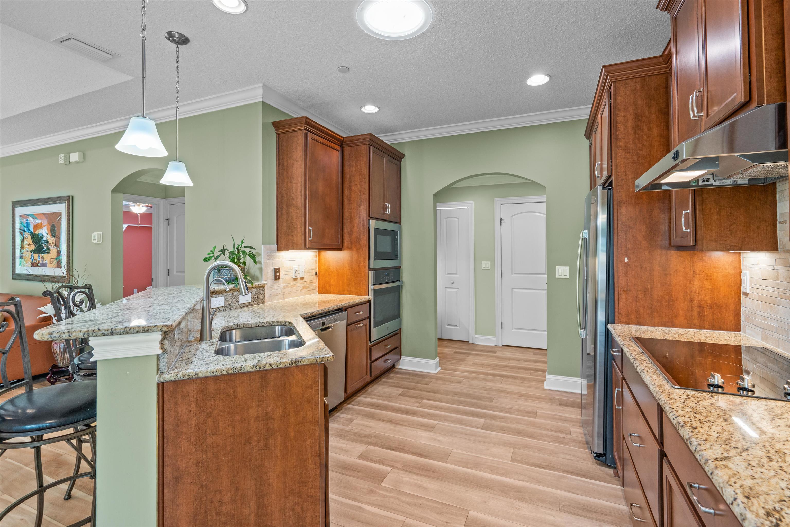 148 Timoga Trail St. Augustine, FL 32084 - Photo 15 of 46 a kitchen with stainless steel appliances granite countertop a sink stove and refrigerator