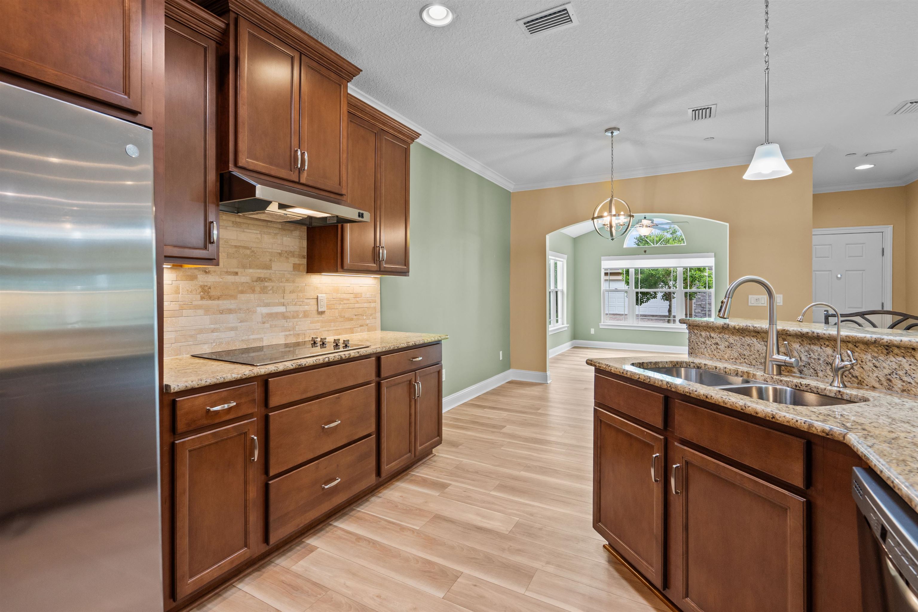 148 Timoga Trail St. Augustine, FL 32084 - Photo 17 of 46 a kitchen with stainless steel appliances granite countertop wooden cabinets a sink a stove a refrigerator and island