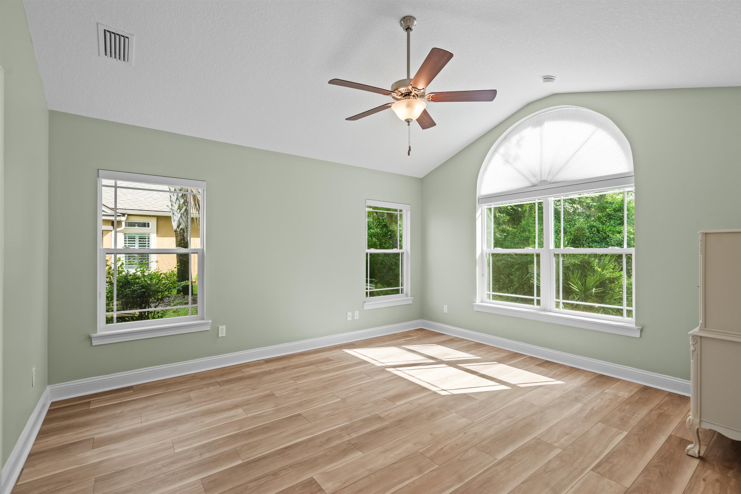 148 Timoga Trail St. Augustine, FL 32084 - Photo 24 of 46 a view of an empty room with wooden floor and a window