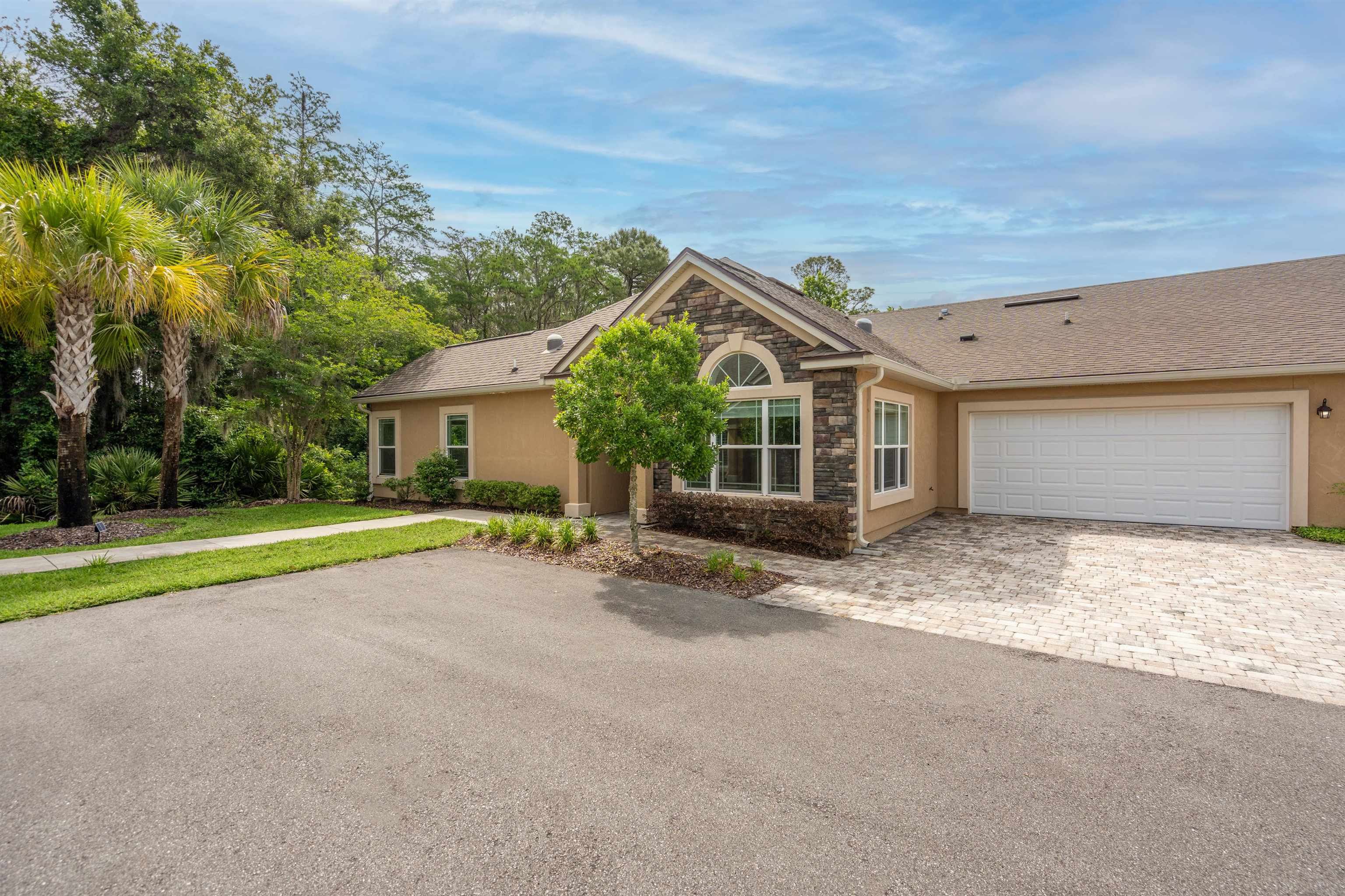 148 Timoga Trail St. Augustine, FL 32084 - Photo 34 of 46 a view of a house with a patio and a yard