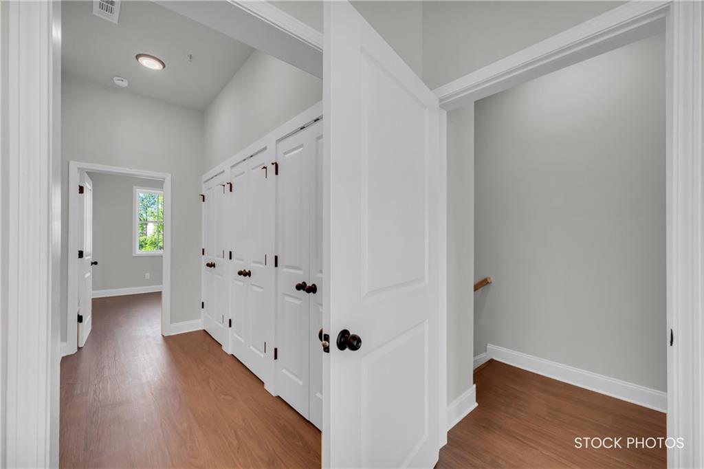 1038 Homestead Way Street Dacula, GA 30019 - Photo 14 of 36 a view of a hallway with wooden floor