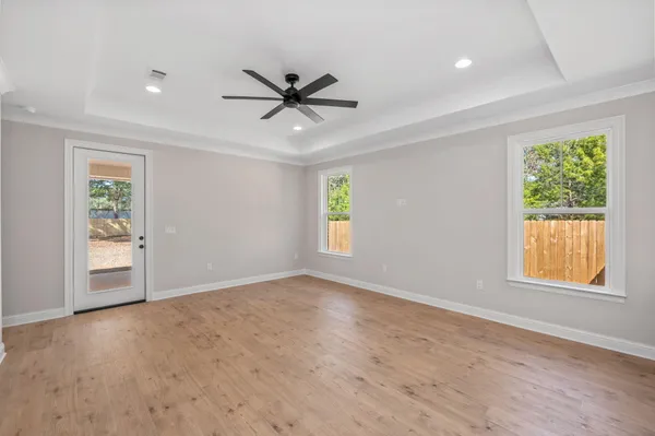 an empty room with windows and closet