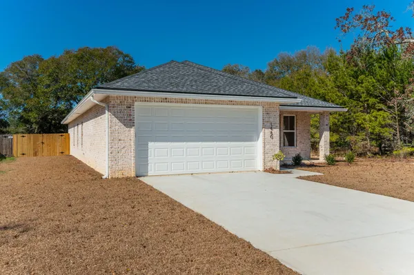 a front view of a house with a garage and a yard