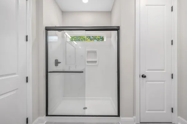 a bathroom with a glass shower door