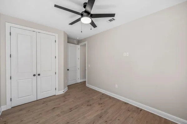 a view of a room with wooden floor