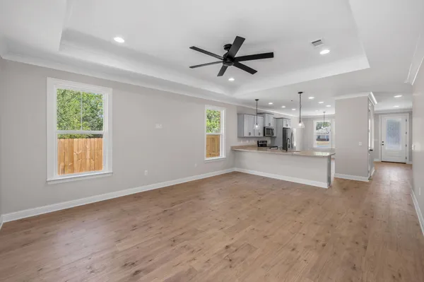 a view of a livingroom with a ceiling fan and window