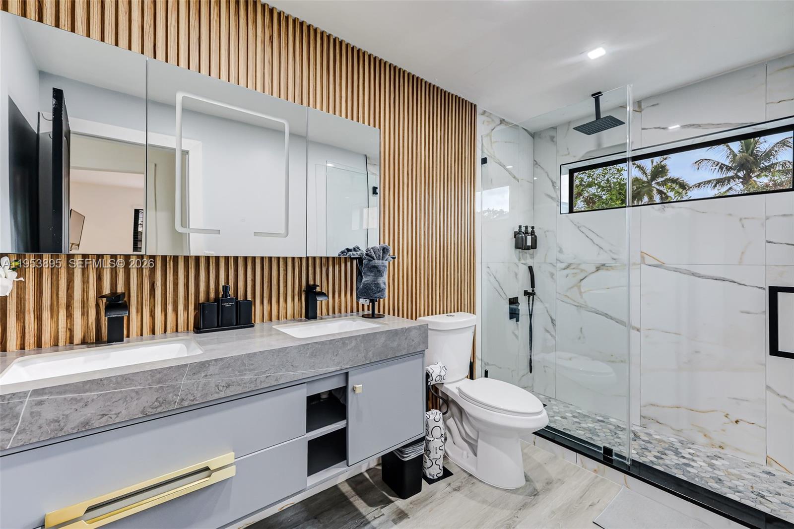 10870 Southwest 106th Avenue Miami, FL 33176 - Photo 19 of 48 a bathroom with a granite countertop sink a toilet a mirror and shower