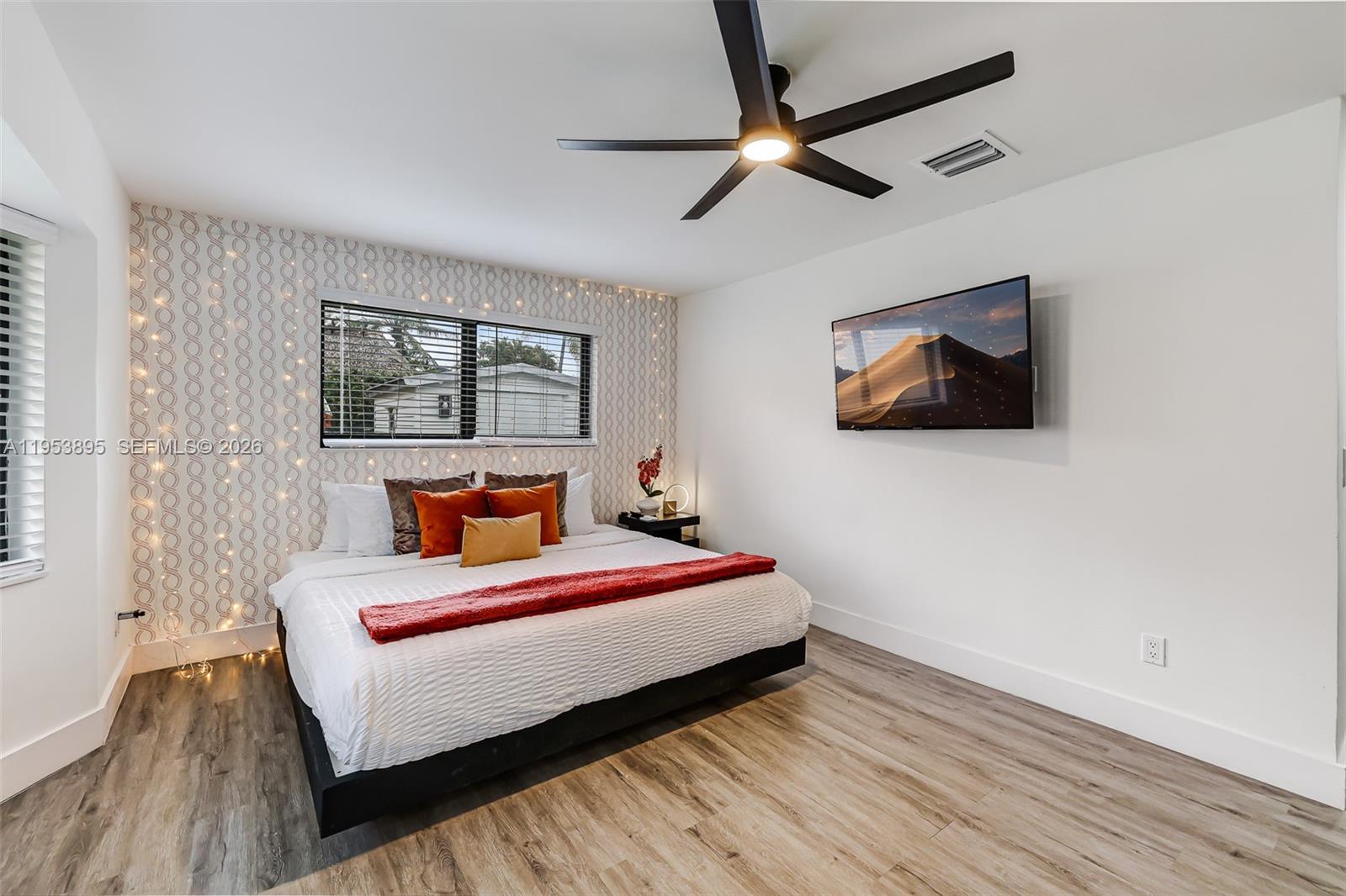 10870 Southwest 106th Avenue Miami, FL 33176 - Photo 31 of 48 a bedroom with a bed a window and painting on the wall