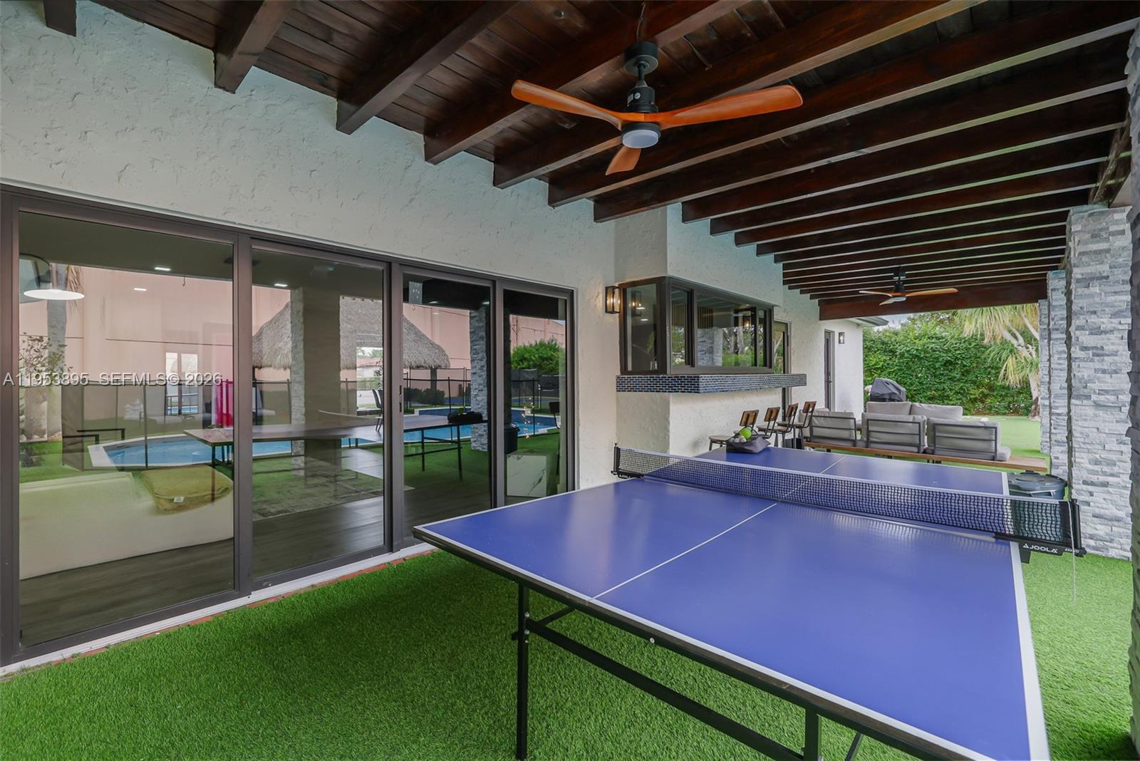 10870 Southwest 106th Avenue Miami, FL 33176 - Photo 34 of 48 a view of a backyard with table and chairs potted plants with wooden floor