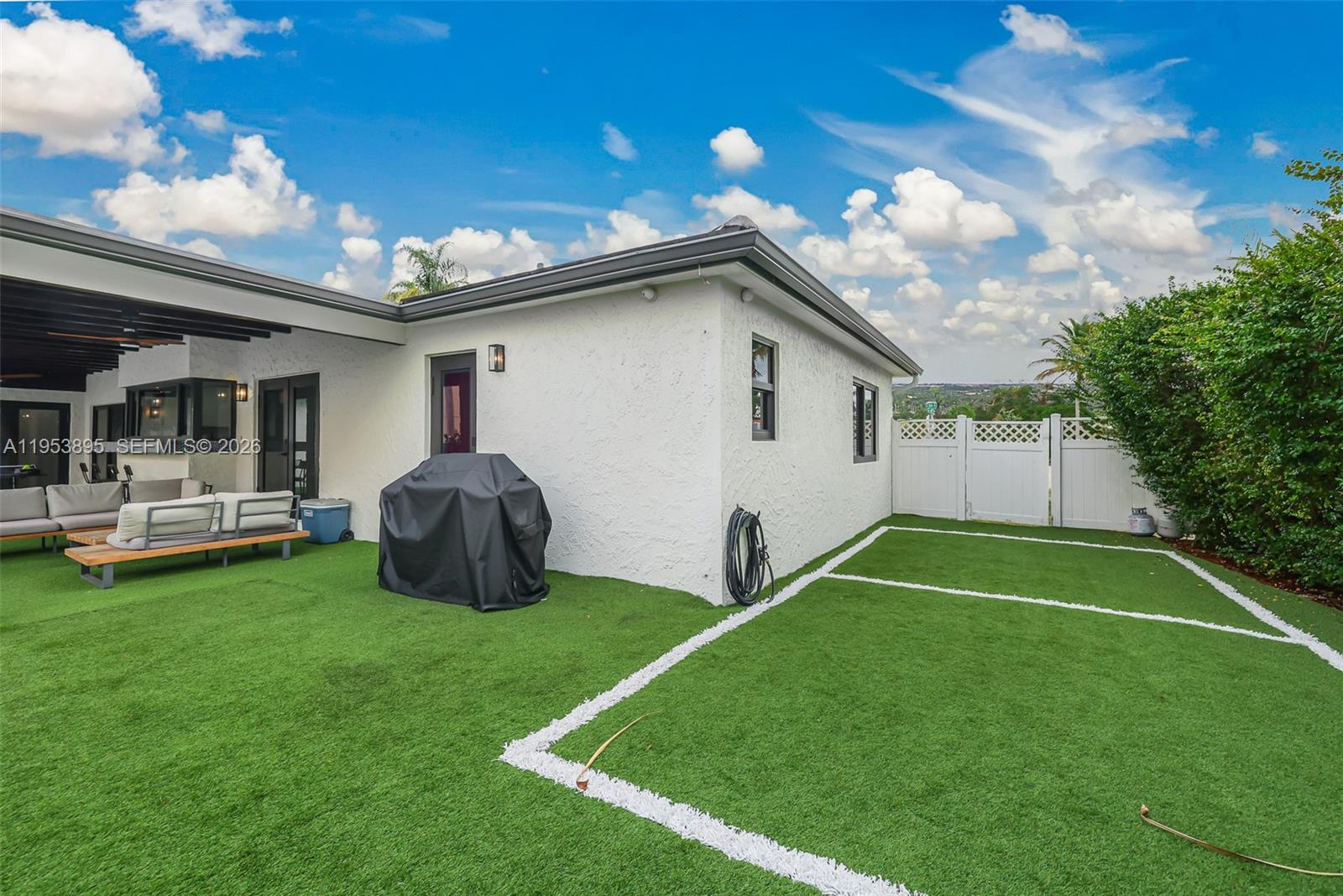 10870 Southwest 106th Avenue Miami, FL 33176 - Photo 36 of 48 a backyard of a house with table and chairs