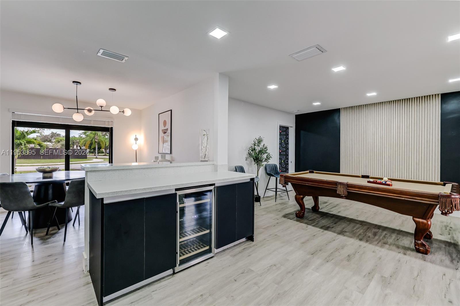 10870 Southwest 106th Avenue Miami, FL 33176 - Photo 7 of 48 a kitchen with kitchen island a sink table and chairs