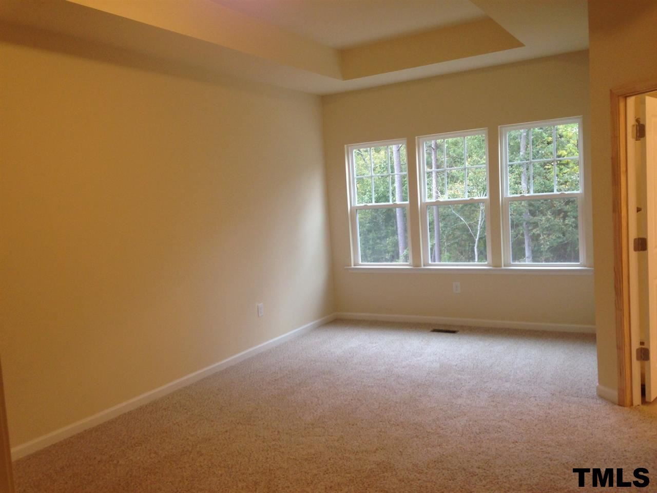 714 Edgewater Ridge Court Apex, NC 27523 - Photo 7 of 8 Master bedroom has 10' trey ceiling and sitting area for desk, TV, etc.