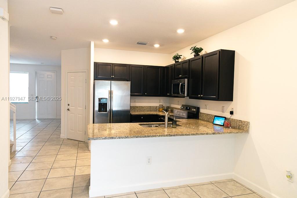 3434 West 104th Terrace Hialeah, FL 33018 - Photo 1 of 28 a kitchen with stainless steel appliances granite countertop a sink and a stove