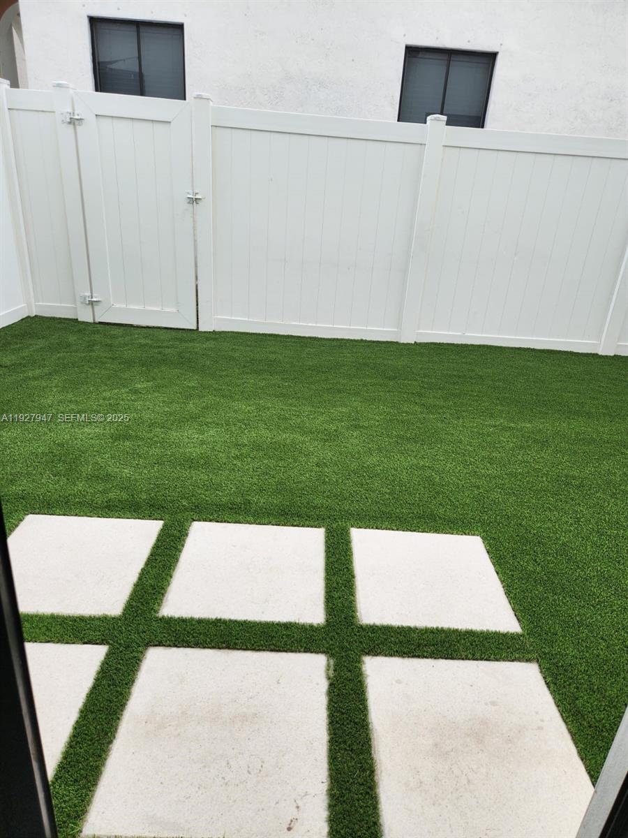 3434 West 104th Terrace Hialeah, FL 33018 - Photo 12 of 28 a picture of a bench in the grass