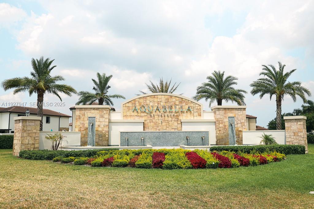 3434 West 104th Terrace Hialeah, FL 33018 - Photo 13 of 28 a front view of multi story residential apartment building with yard and flowers
