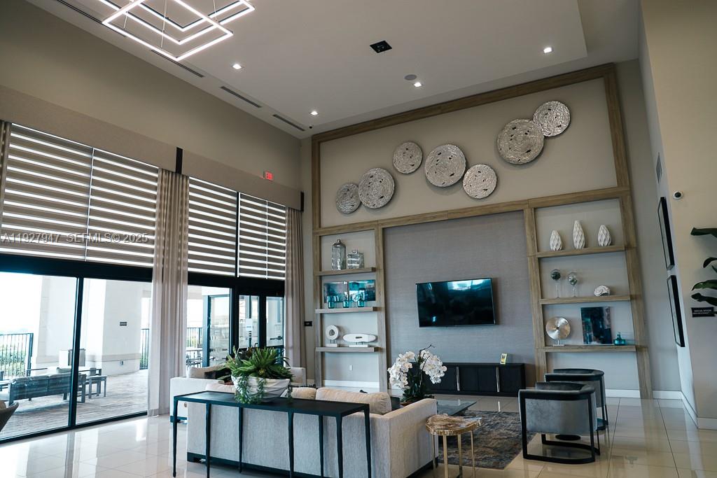 3434 West 104th Terrace Hialeah, FL 33018 - Photo 16 of 28 a living room with furniture and a flat screen tv
