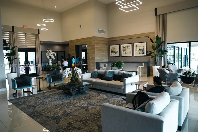 a living room with furniture and a floor to ceiling window