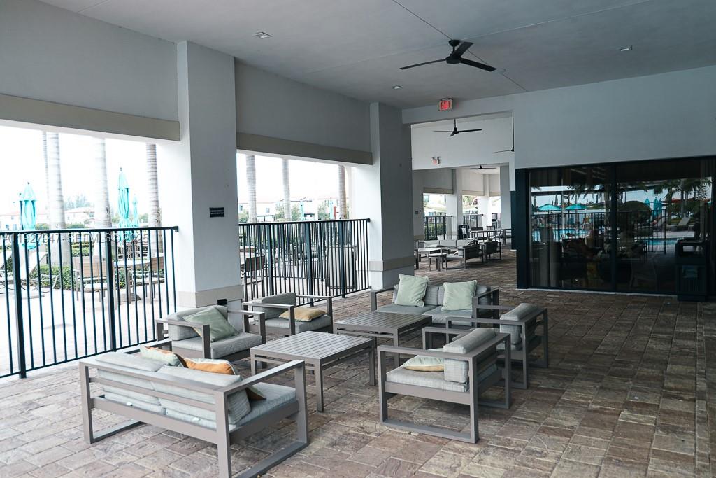 3434 West 104th Terrace Hialeah, FL 33018 - Photo 18 of 28 a living room with furniture and a floor to ceiling window