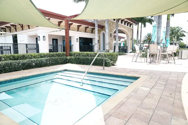 aerial view of a house with a swimming pool and sitting area