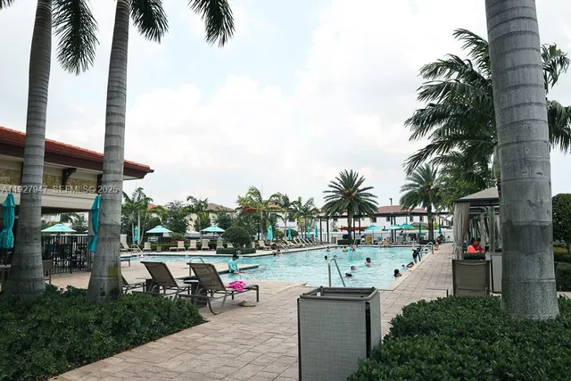 a very nice looking living room with a large window and potted plants