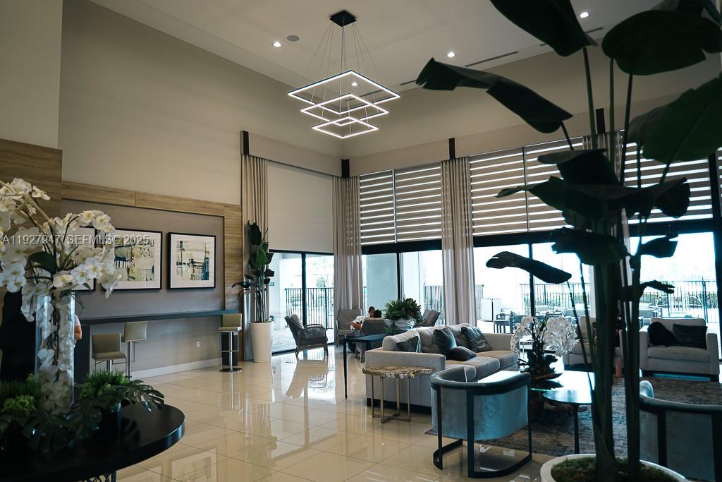 3434 West 104th Terrace Hialeah, FL 33018 - Photo 25 of 28 a very nice looking living room with a large window and potted plants