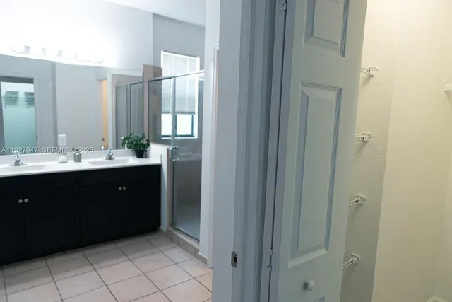 a bathroom with a double vanity sink and mirror