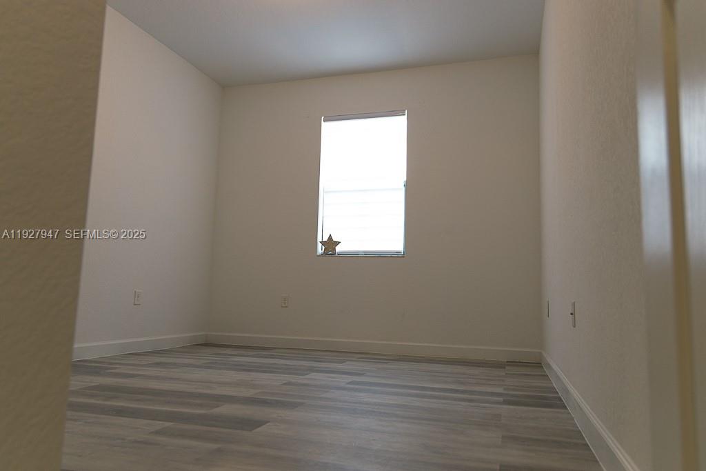 3434 West 104th Terrace Hialeah, FL 33018 - Photo 8 of 28 a view of a small space with wooden floor and a window