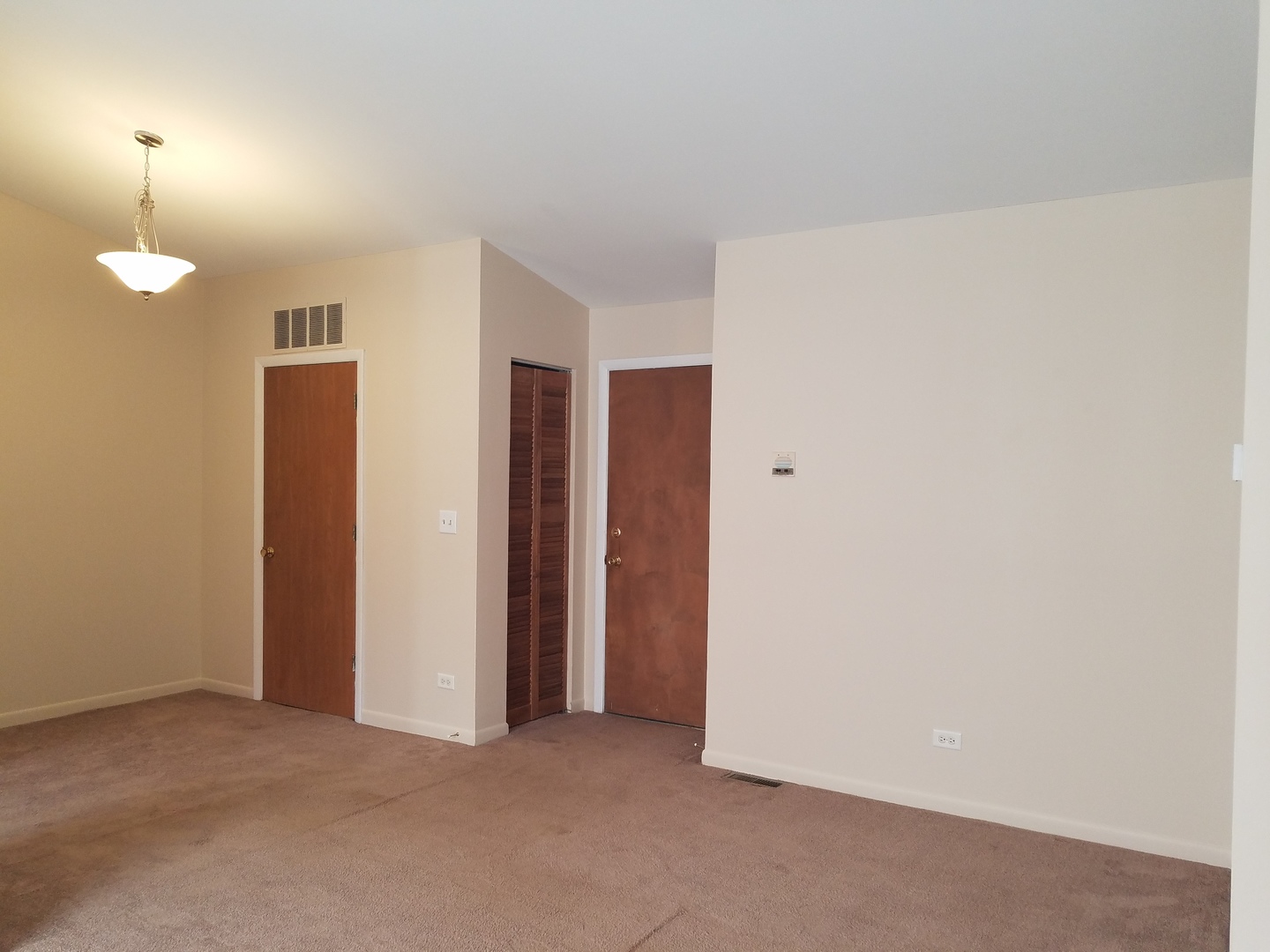 146 West Golf Road, Unit C Libertyville, IL 60048 - Photo 5 of 24 an empty room with closet and a bathroom