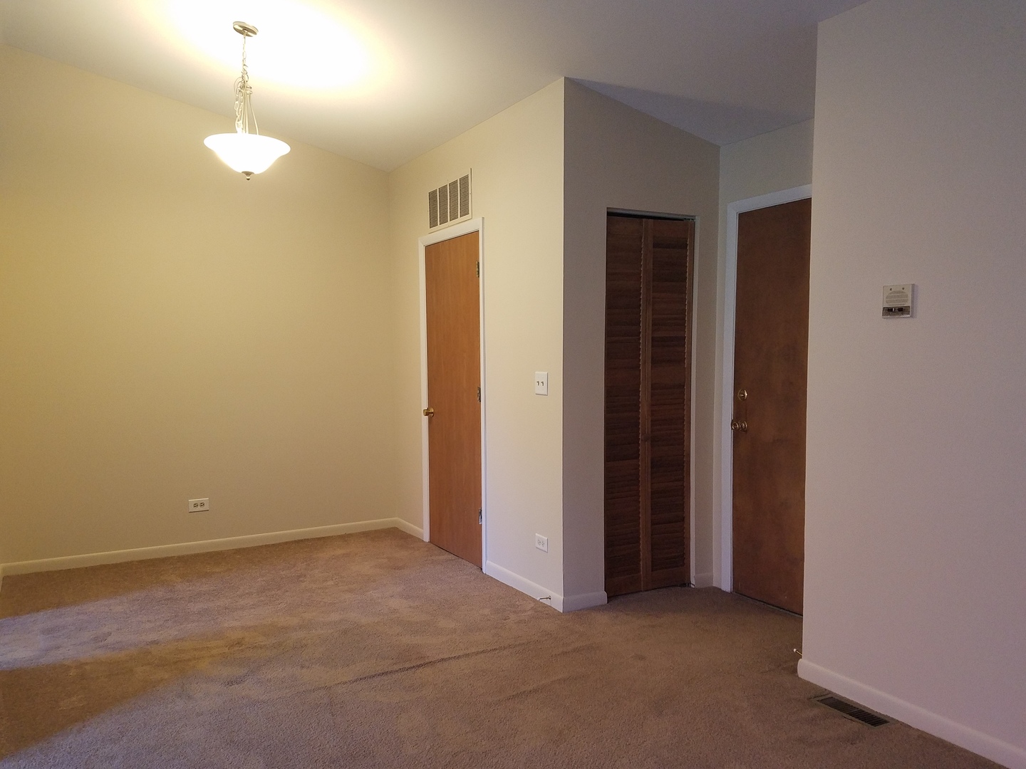 146 West Golf Road, Unit C Libertyville, IL 60048 - Photo 6 of 24 a view of an empty room with a window