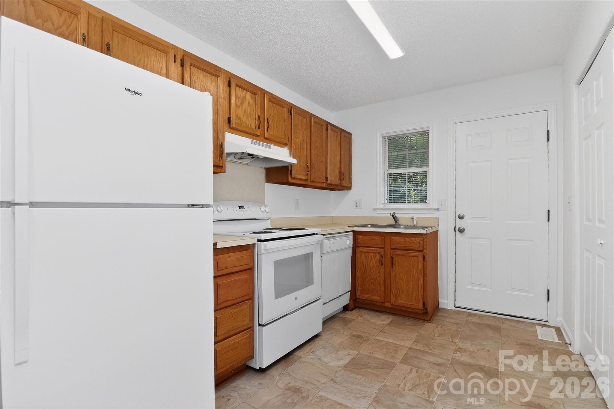 91-93 Sunderland Road Southwest, Unit 93 Concord, NC 28027 - Photo 12 of 30 a kitchen with stainless steel appliances granite countertop a refrigerator and a stove