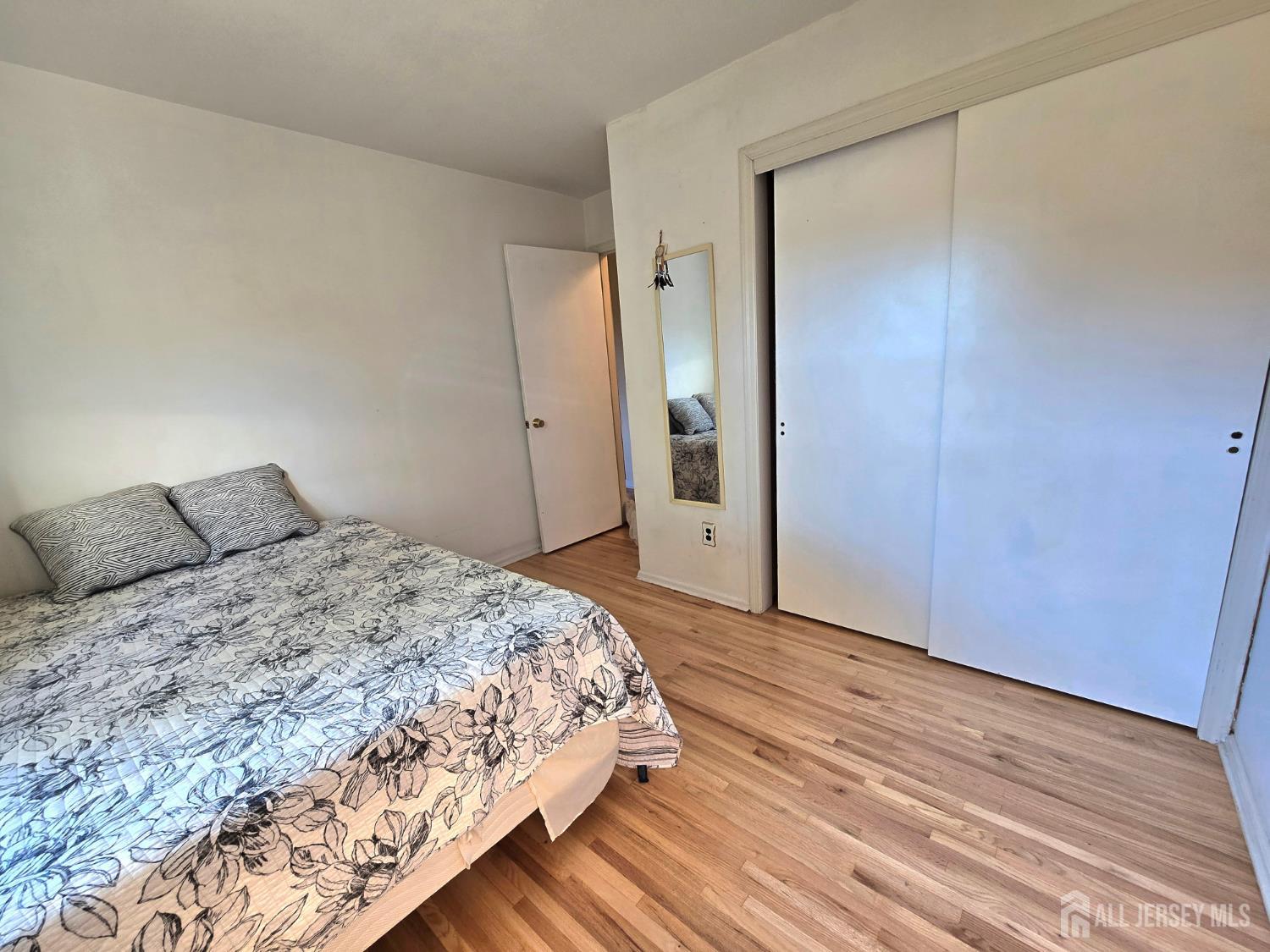 124 Howell Avenue Fords, NJ 08863 - Photo 12 of 23 a bedroom with a bed and wooden floor