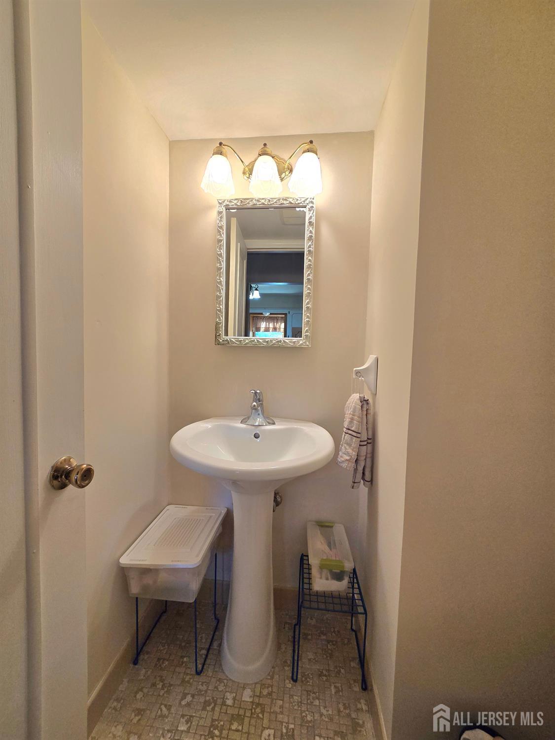 124 Howell Avenue Fords, NJ 08863 - Photo 18 of 23 a bathroom with a sink a mirror and a toilet