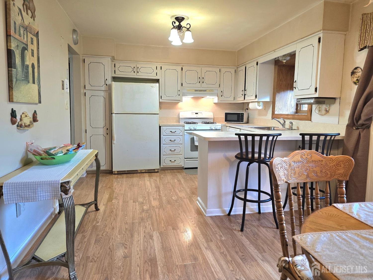 124 Howell Avenue Fords, NJ 08863 - Photo 3 of 23 a kitchen with stainless steel appliances granite countertop a dining table chairs refrigerator sink and cabinets