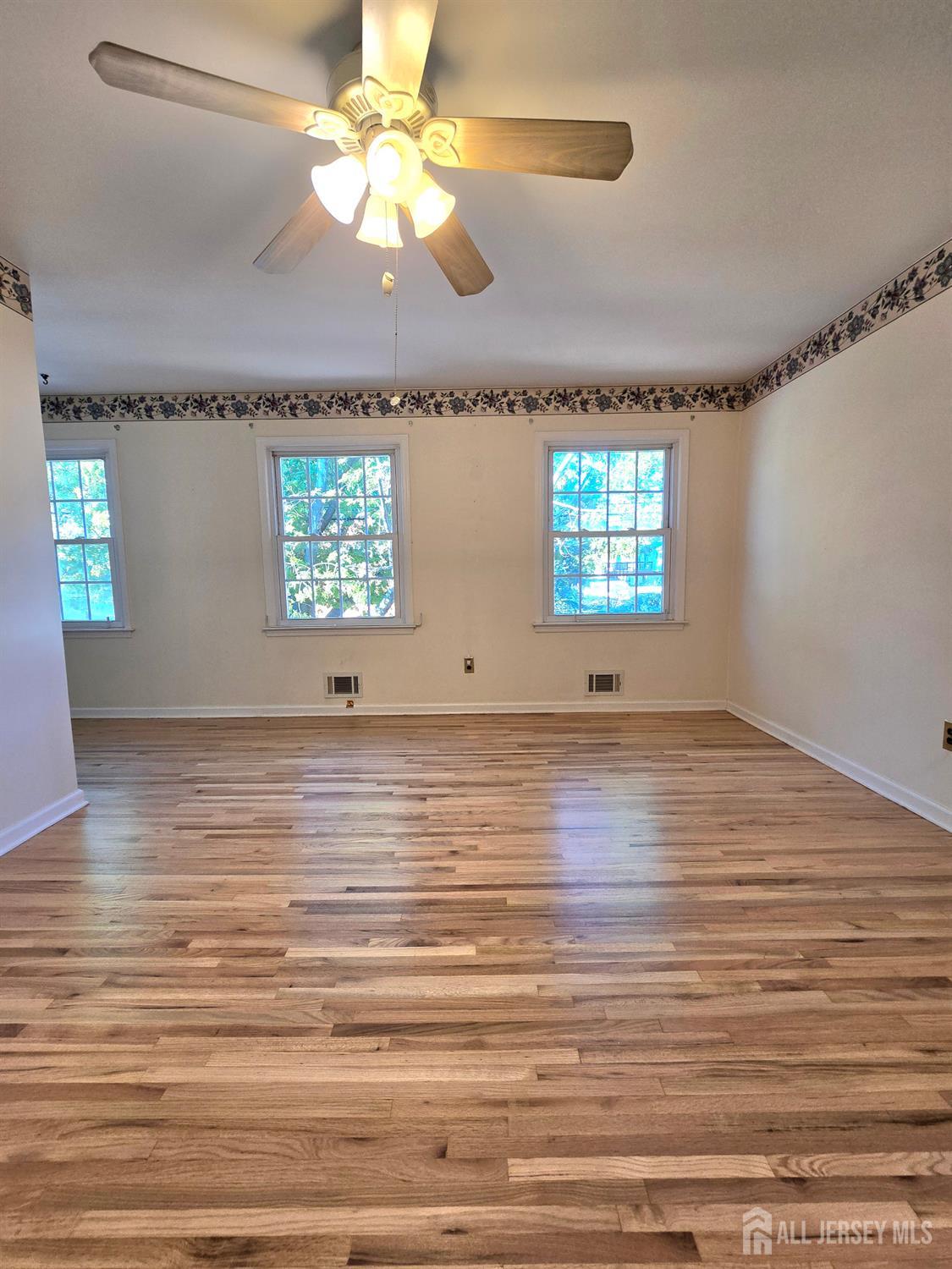 124 Howell Avenue Fords, NJ 08863 - Photo 9 of 23 wooden floor in an empty room with a window