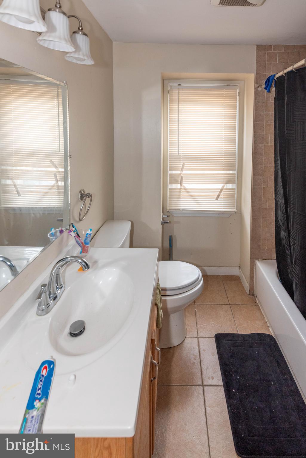 5686 Utrecht Road Baltimore, MD 21206 - Photo 12 of 35 a bathroom with a sink a toilet and tub